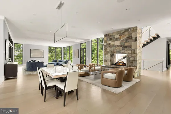 a living room with furniture a flat screen tv and a large window