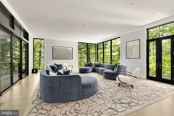 a living room with furniture and large windows