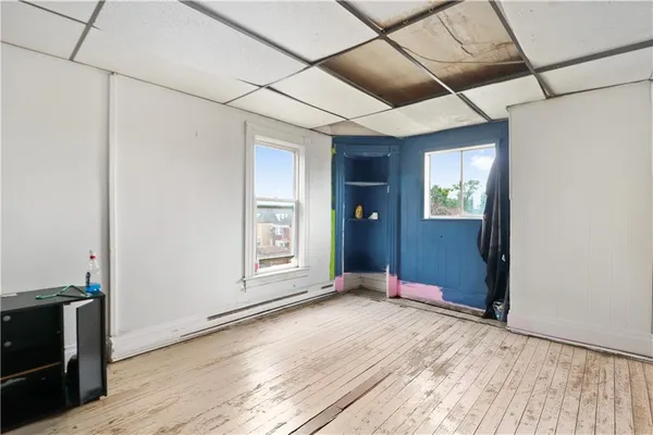a view of a room with wooden floor