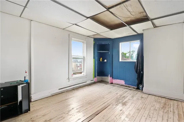 a view of a room with wooden floor