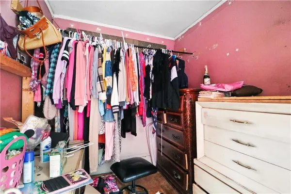 a bedroom with furniture and a flat screen tv