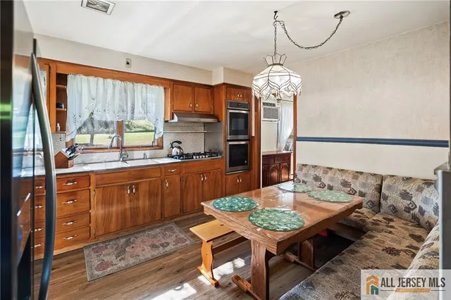 a view of a kitchen with a dining table and chairs