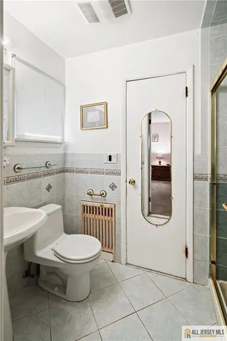 a bathroom with a toilet a sink a mirror and vanity
