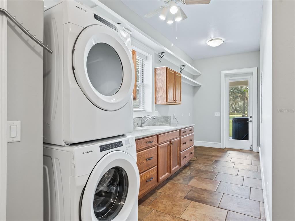 402 Southwest 127th Place Ocala, FL 34473 - Photo 19 of 75 a large bathroom with a sink a mirror and a washer