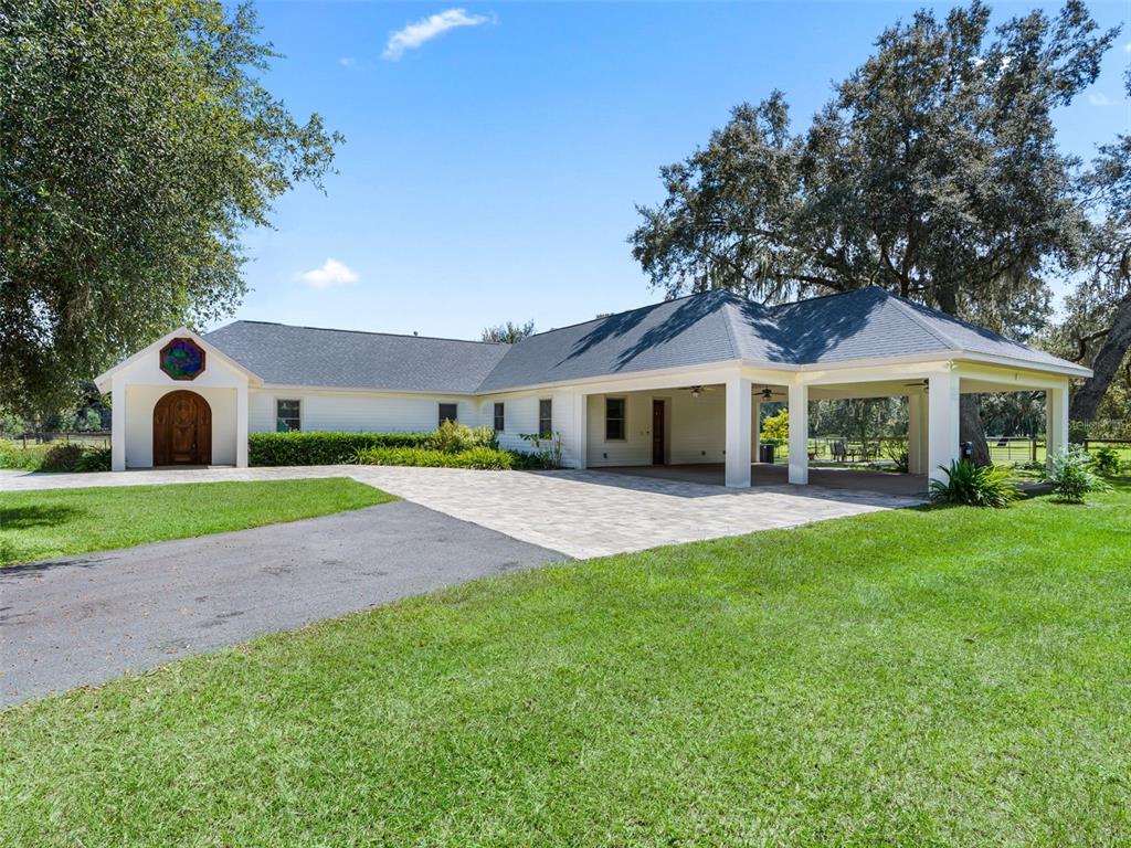 402 Southwest 127th Place Ocala, FL 34473 - Photo 2 of 75 a view of house with a yard