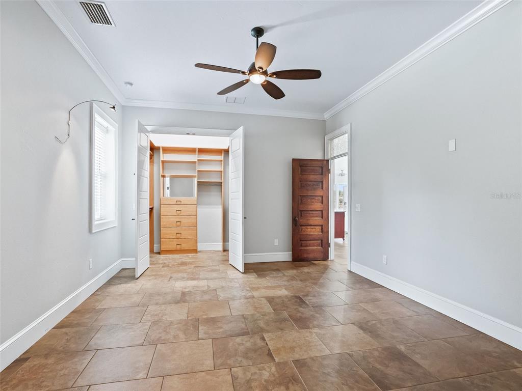 402 Southwest 127th Place Ocala, FL 34473 - Photo 23 of 75 a view of an empty room with window and chandelier fan