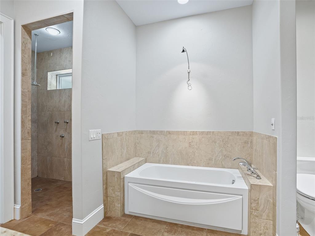 402 Southwest 127th Place Ocala, FL 34473 - Photo 27 of 75 a bathroom with a bathtub and shower