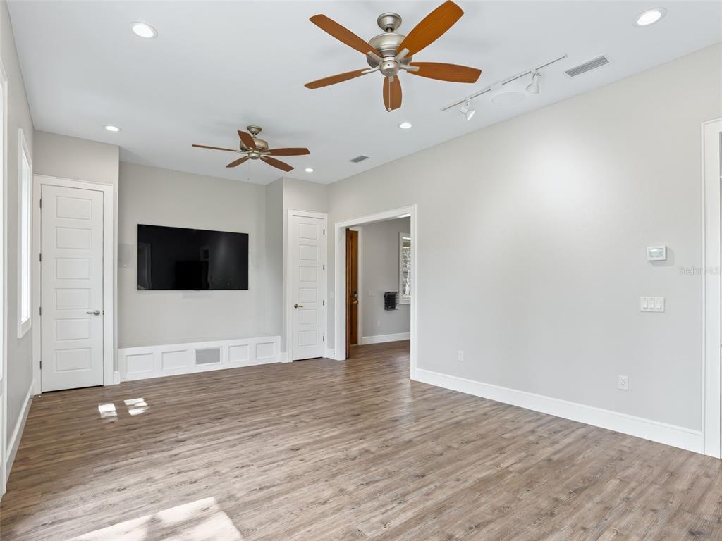 402 Southwest 127th Place Ocala, FL 34473 - Photo 35 of 75 wooden floor in an empty room with a ceiling fan