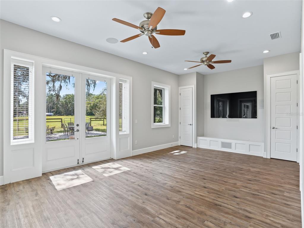 402 Southwest 127th Place Ocala, FL 34473 - Photo 36 of 75 a view of empty room with wooden floor and fan