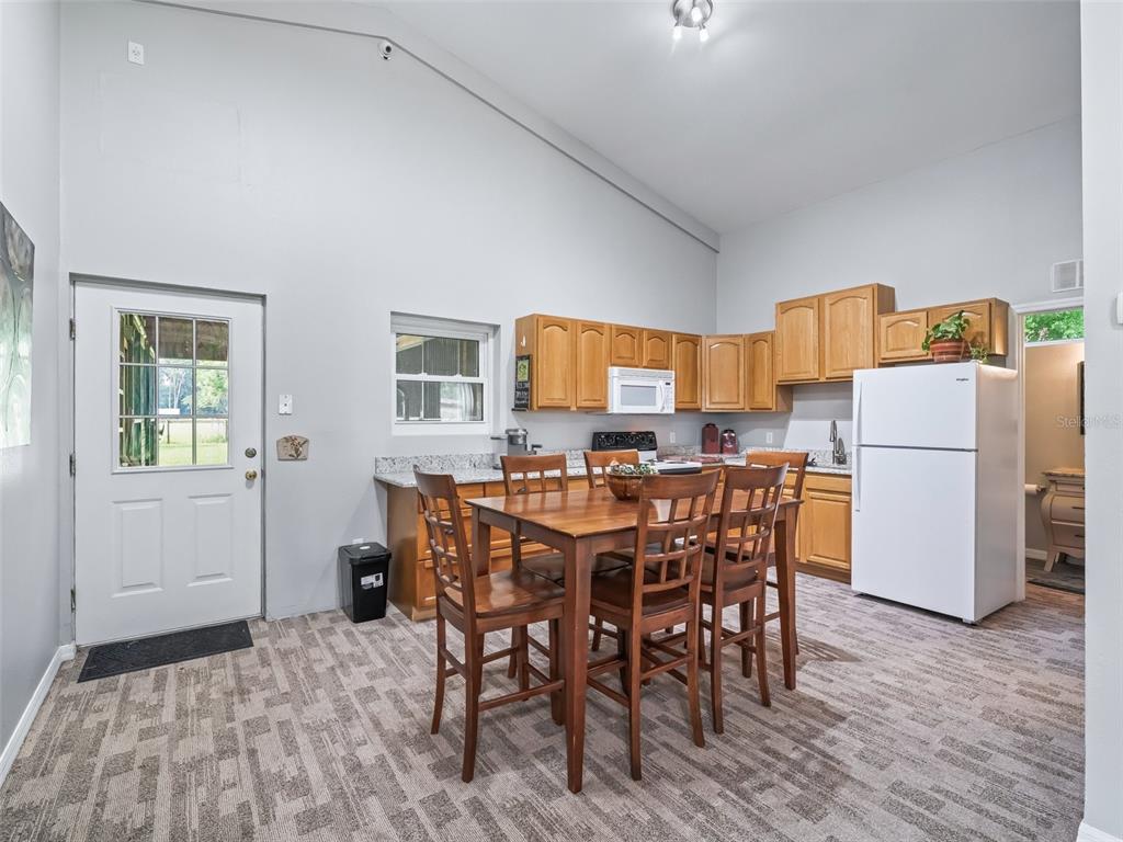 402 Southwest 127th Place Ocala, FL 34473 - Photo 52 of 75 a view of a dining room with furniture and wooden floor