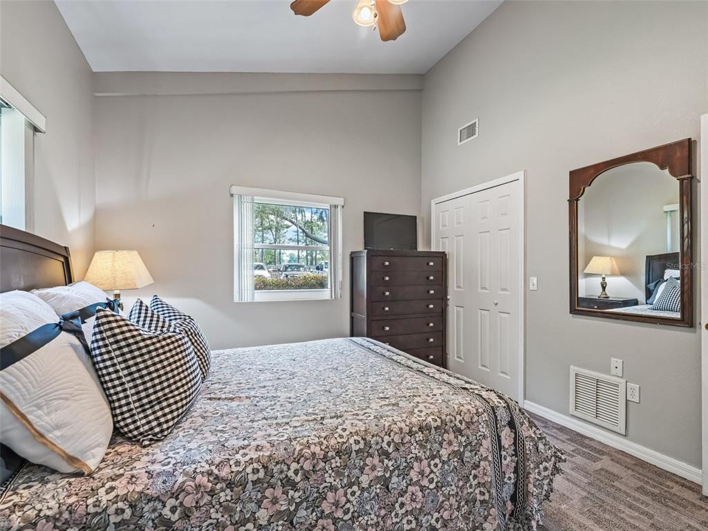 402 Southwest 127th Place Ocala, FL 34473 - Photo 57 of 75 a bedroom with a bed and a painting on the wall