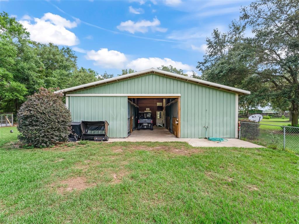 402 Southwest 127th Place Ocala, FL 34473 - Photo 67 of 75 a front view of a house with patio and garden