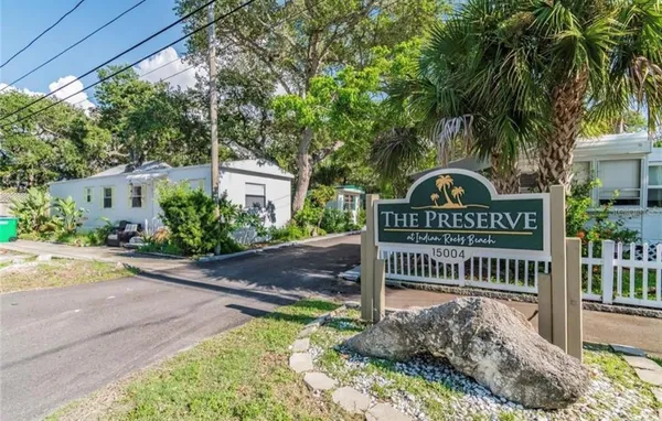 a front view of a house with garden and deck