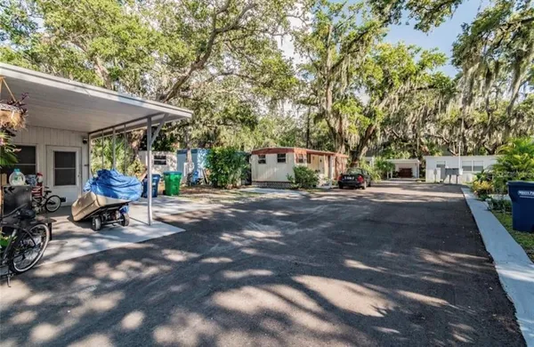 a view of a patio with table and chairs under an umbrella