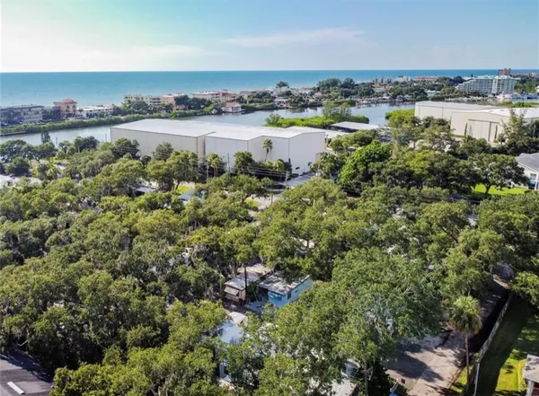 an aerial view of a houses with outdoor space and swimming pool