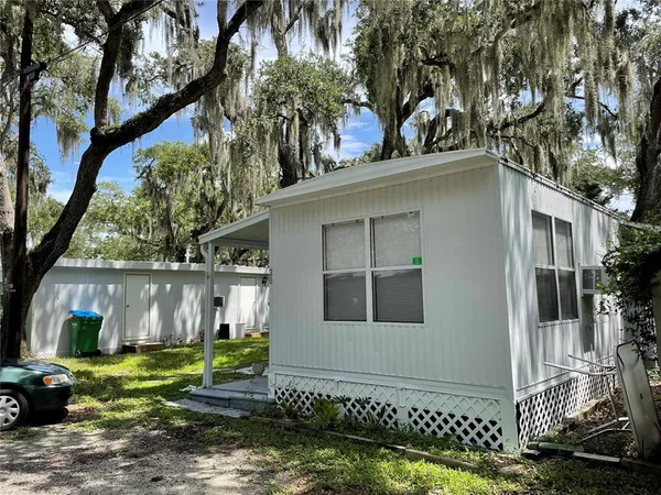 a house that has a tree in front of it