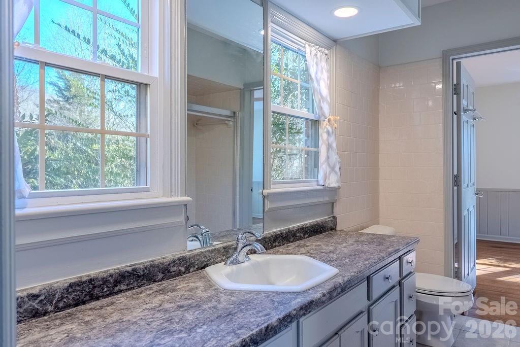 2212 Wayah Road Franklin, NC 28734 - Photo 15 of 47 a bathroom with a granite countertop sink and a mirror
