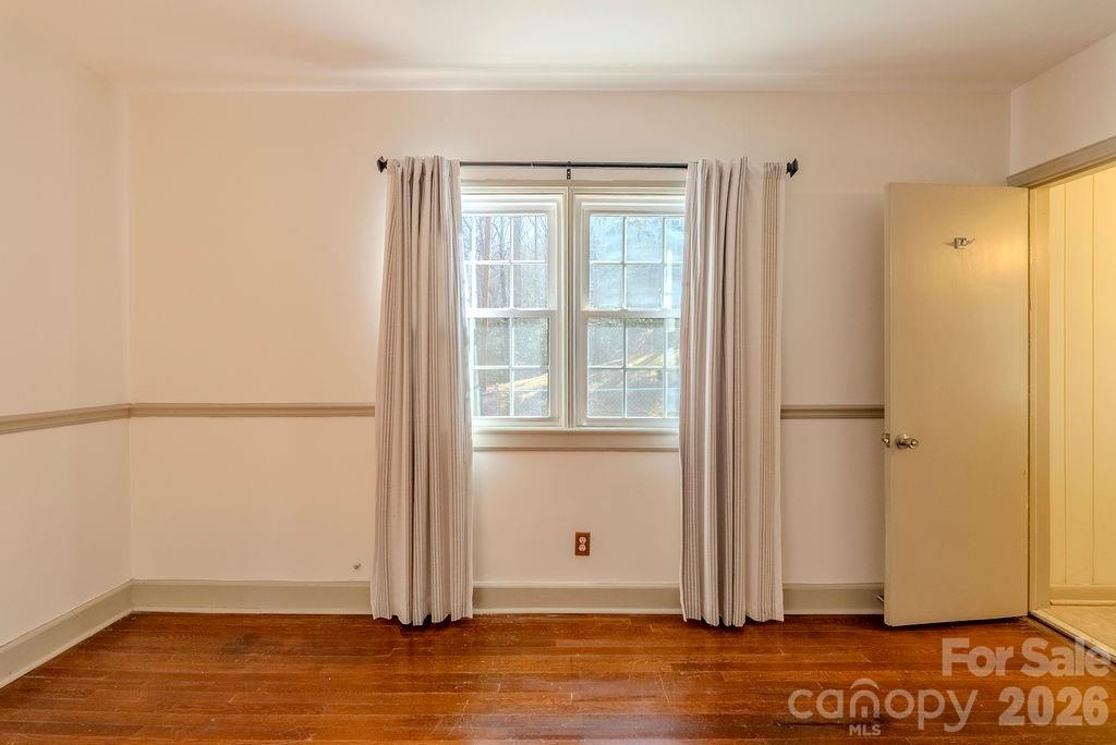2212 Wayah Road Franklin, NC 28734 - Photo 17 of 47 an empty room with wooden floor and windows