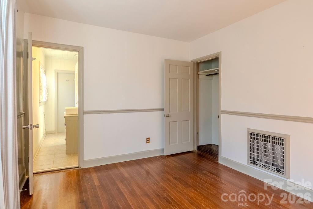 2212 Wayah Road Franklin, NC 28734 - Photo 18 of 47 an empty room with wooden floor and windows