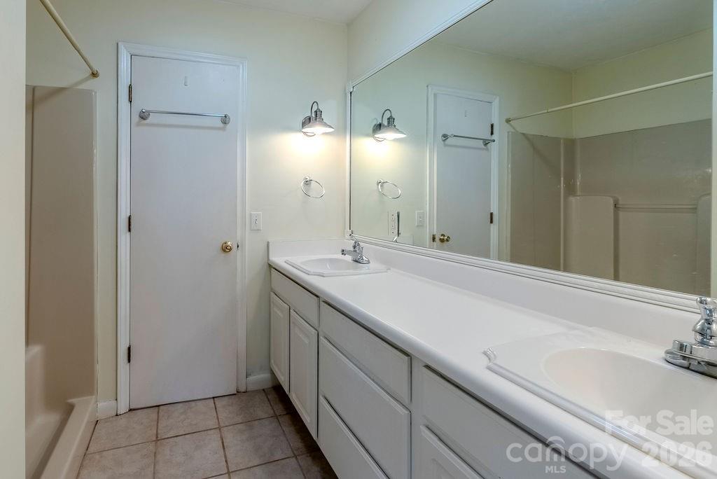 2212 Wayah Road Franklin, NC 28734 - Photo 19 of 47 a spacious bathroom with a granite countertop sink mirror and double