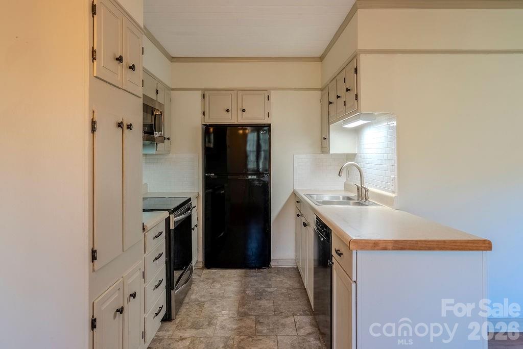 2212 Wayah Road Franklin, NC 28734 - Photo 2 of 47 a kitchen with cabinets and stainless steel appliances
