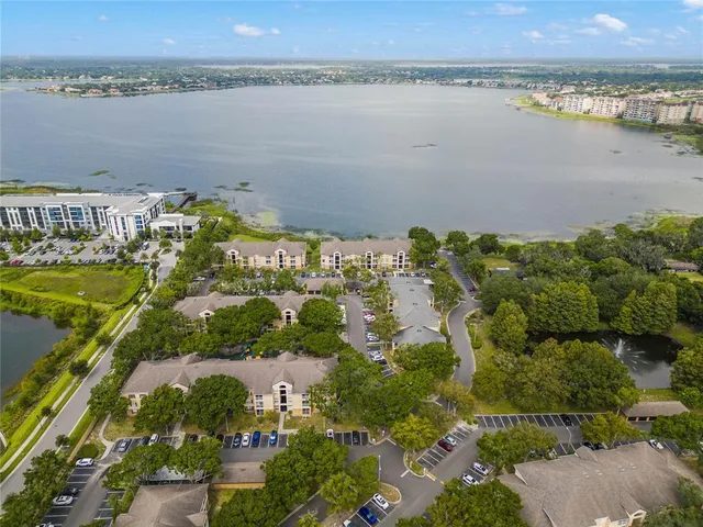 an aerial view of a residential houses with outdoor space and ocean view