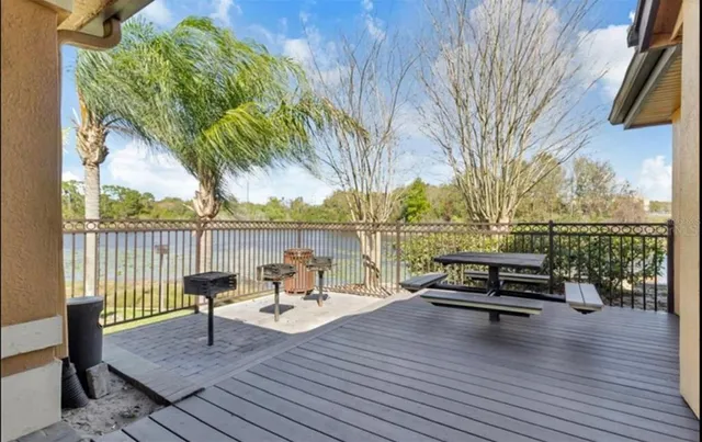 a view of roof deck with seating space and trees