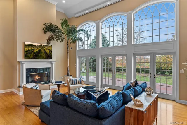 a living room with furniture fireplace and a large window