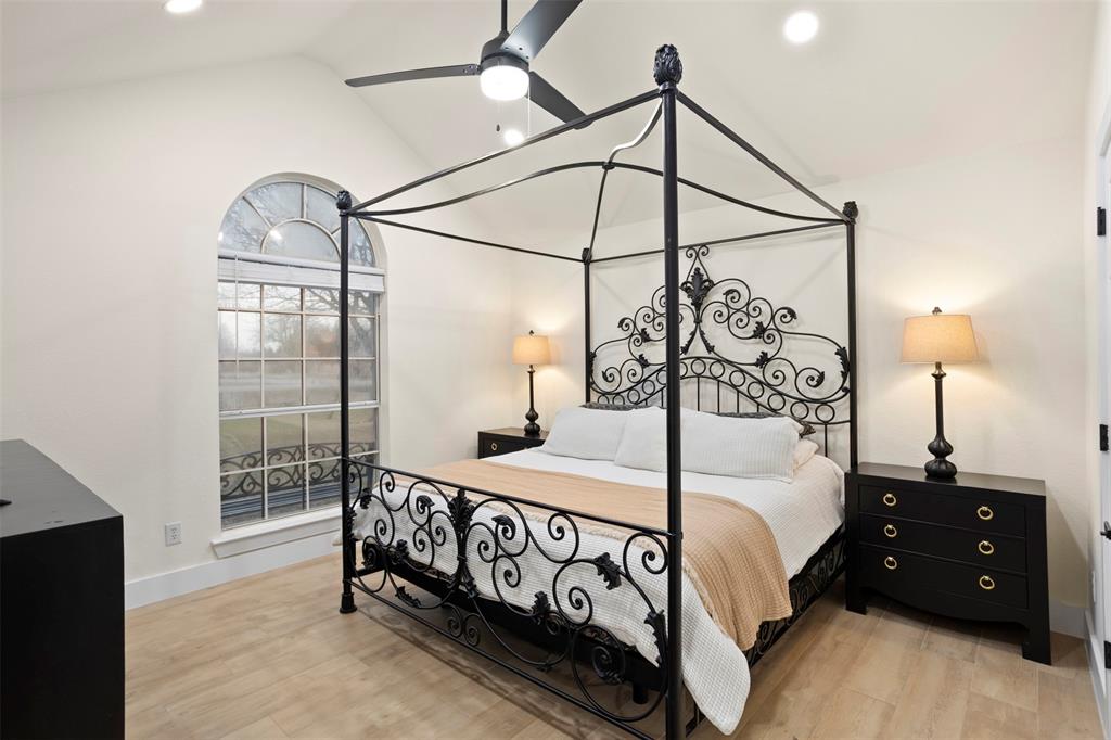 1121 Pierce Road Red Oak, TX 75154 - Photo 19 of 40 a bedroom with a bed a lamp and window