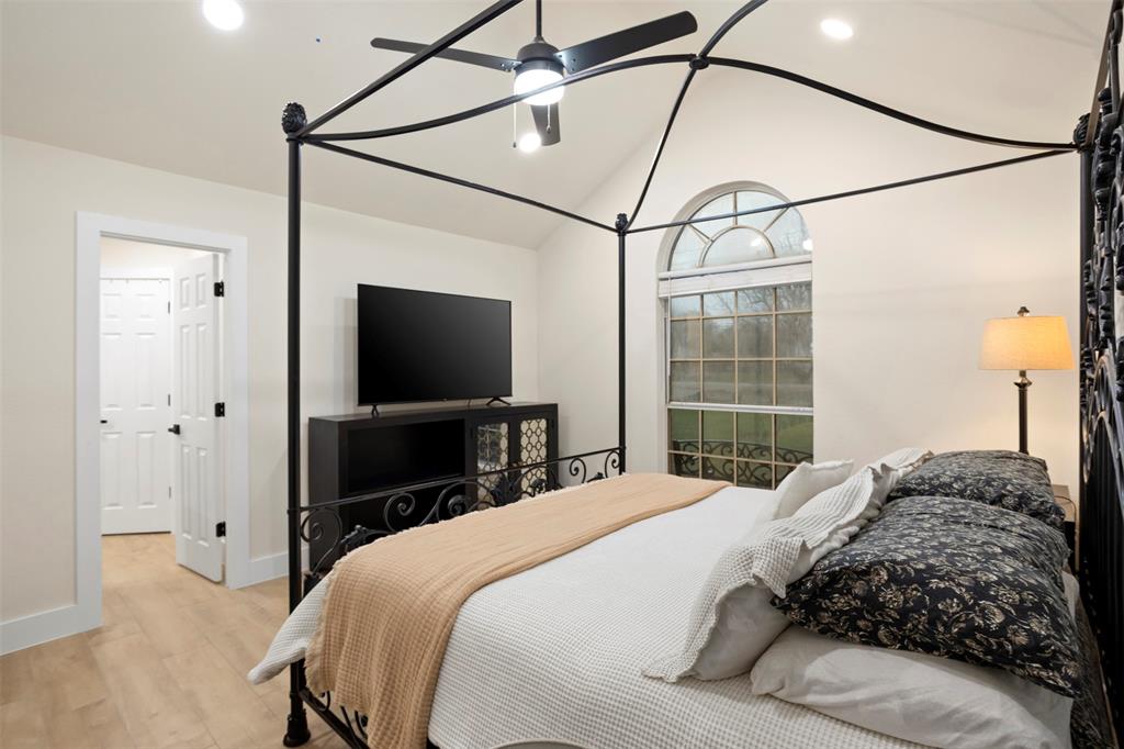 1121 Pierce Road Red Oak, TX 75154 - Photo 20 of 40 a bedroom with a bed and a flat screen tv