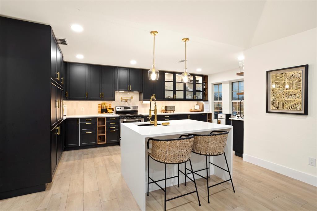 1121 Pierce Road Red Oak, TX 75154 - Photo 2 of 40 a kitchen with a table chairs refrigerator and chairs