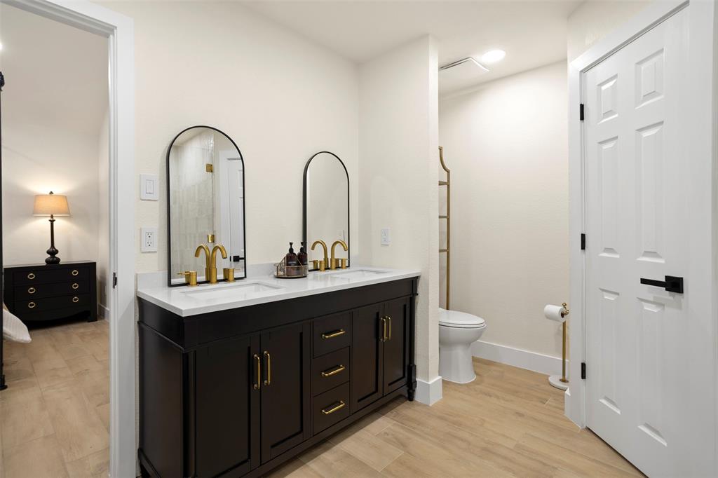 1121 Pierce Road Red Oak, TX 75154 - Photo 23 of 40 a spacious bathroom with a double vanity sink a toilet and a mirror