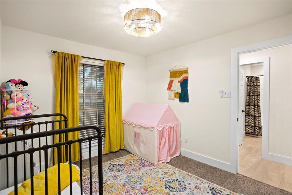 1121 Pierce Road Red Oak, TX 75154 - Photo 25 of 40 a bedroom with furniture and a window