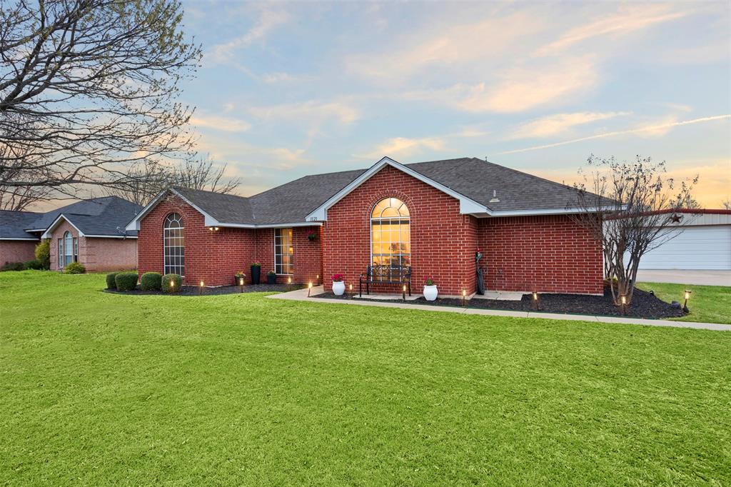 1121 Pierce Road Red Oak, TX 75154 - Photo 5 of 40 a front view of a house with a yard and garage