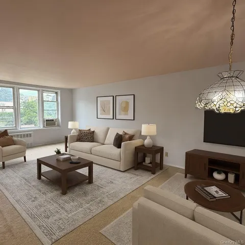 a living room with furniture a fireplace and a chandelier