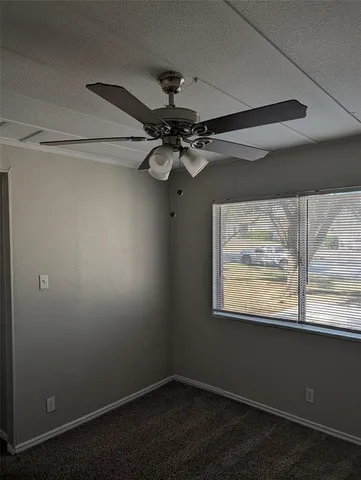 a view of a small space with wooden floor and a window