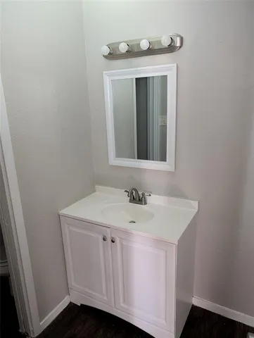 a bathroom with a sink a mirror and vanity