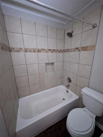 a bathroom with a bathtub and toilet