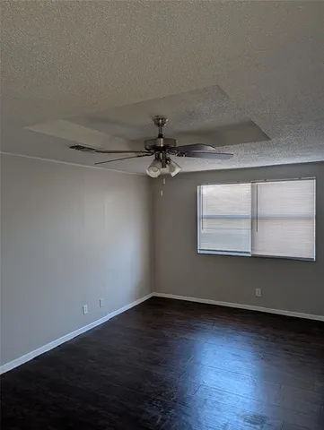 a view of a room with wooden floor and a window