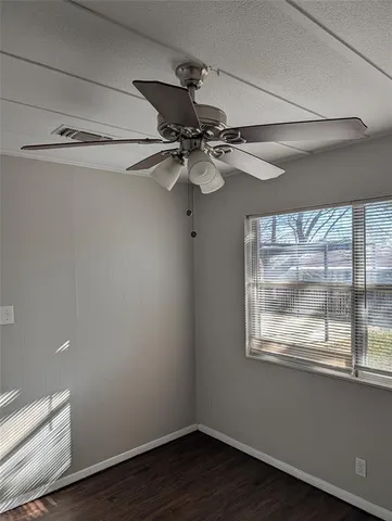 a view of a small space with wooden floor and windows