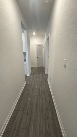 a view of a room with wooden floor