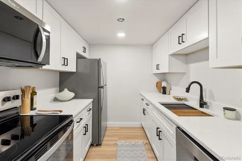 a kitchen with stainless steel appliances a sink stove and refrigerator