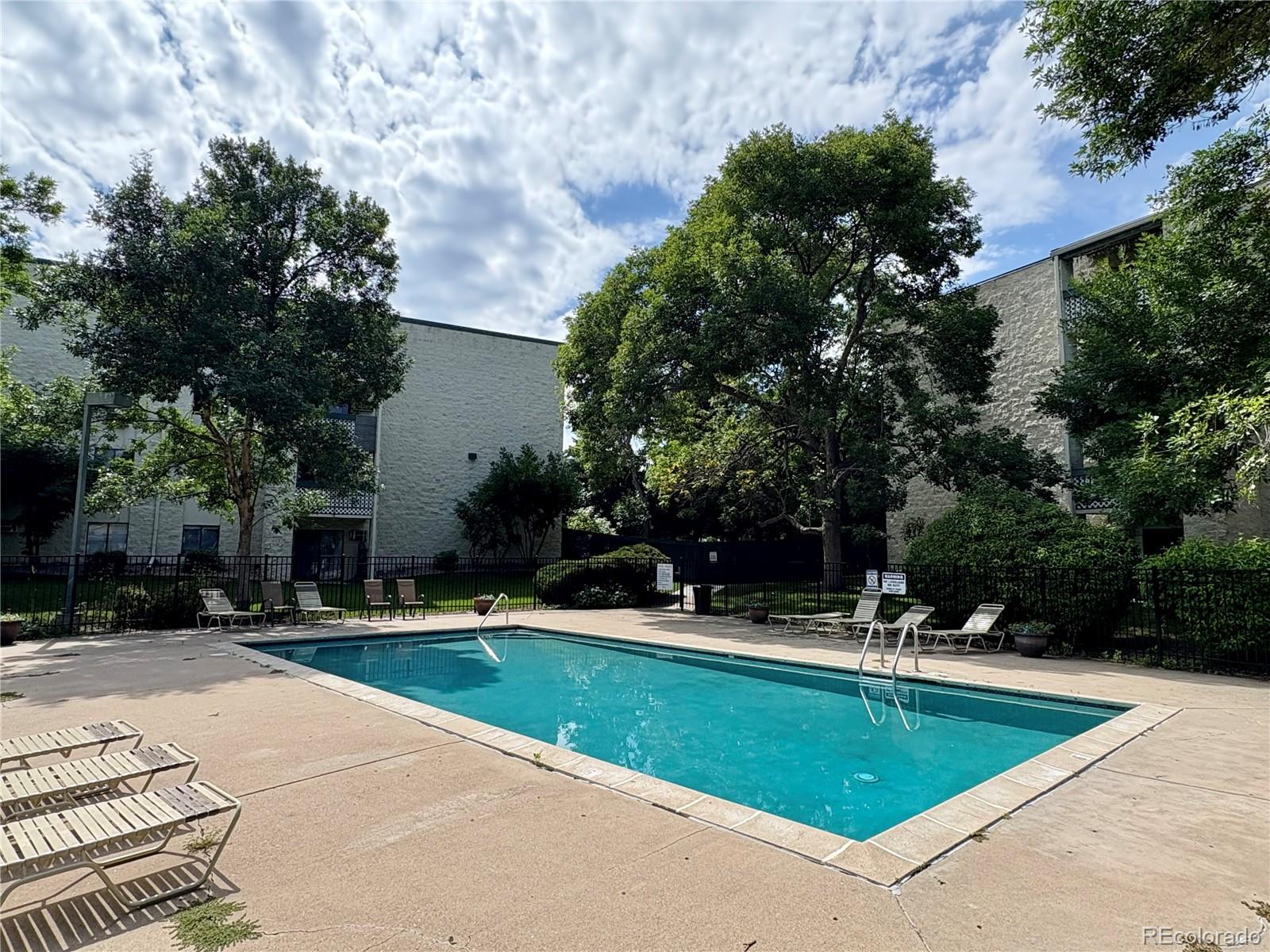 7770 West 38th Avenue, Unit 108 Wheat Ridge, CO 80033 - Photo 5 of 6 a view of a swimming pool with a patio
