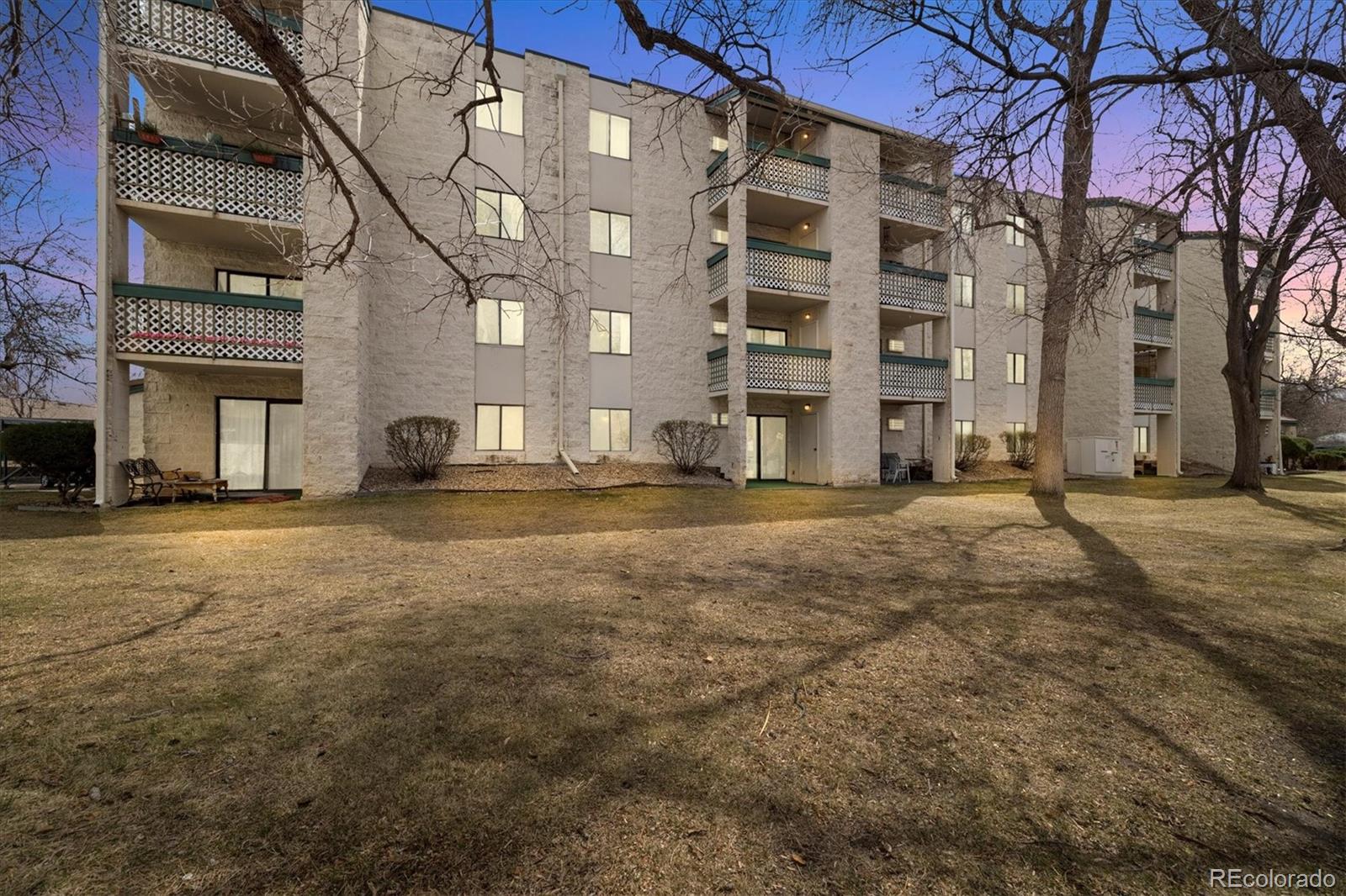 7770 West 38th Avenue, Unit 108 Wheat Ridge, CO 80033 - Photo 6 of 6 a view of a building with a yard