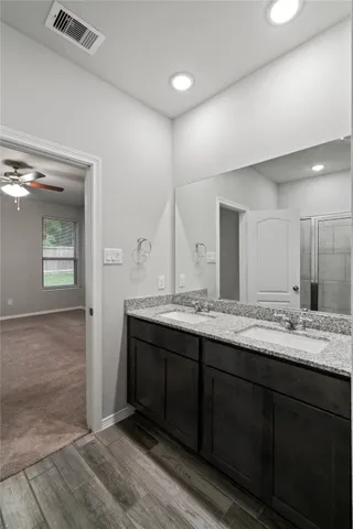 a bathroom with a granite countertop sink and a mirror