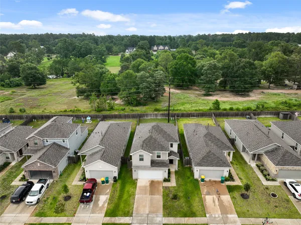an aerial view of a house with big yard