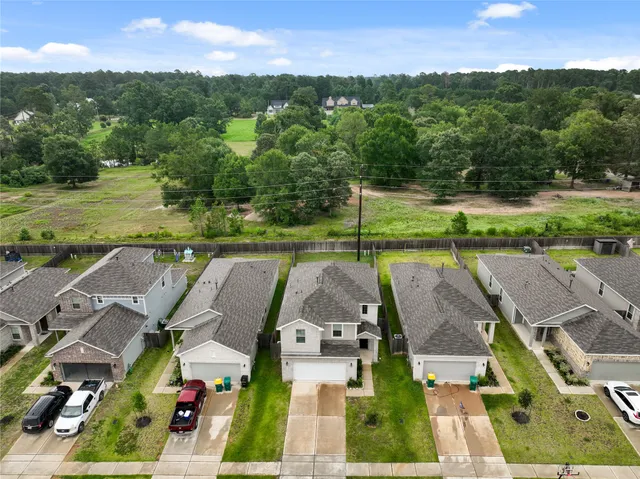 an aerial view of a house with big yard