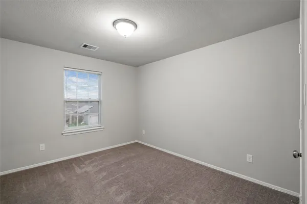 a view of an empty room and a window