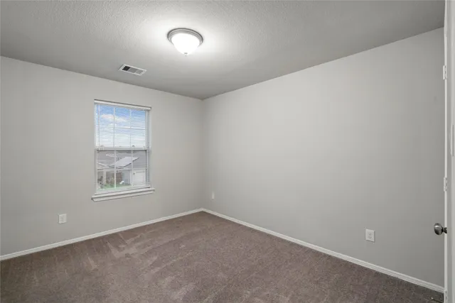 a view of an empty room and a window
