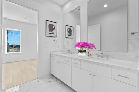 a bathroom with a sink mirror and vanity